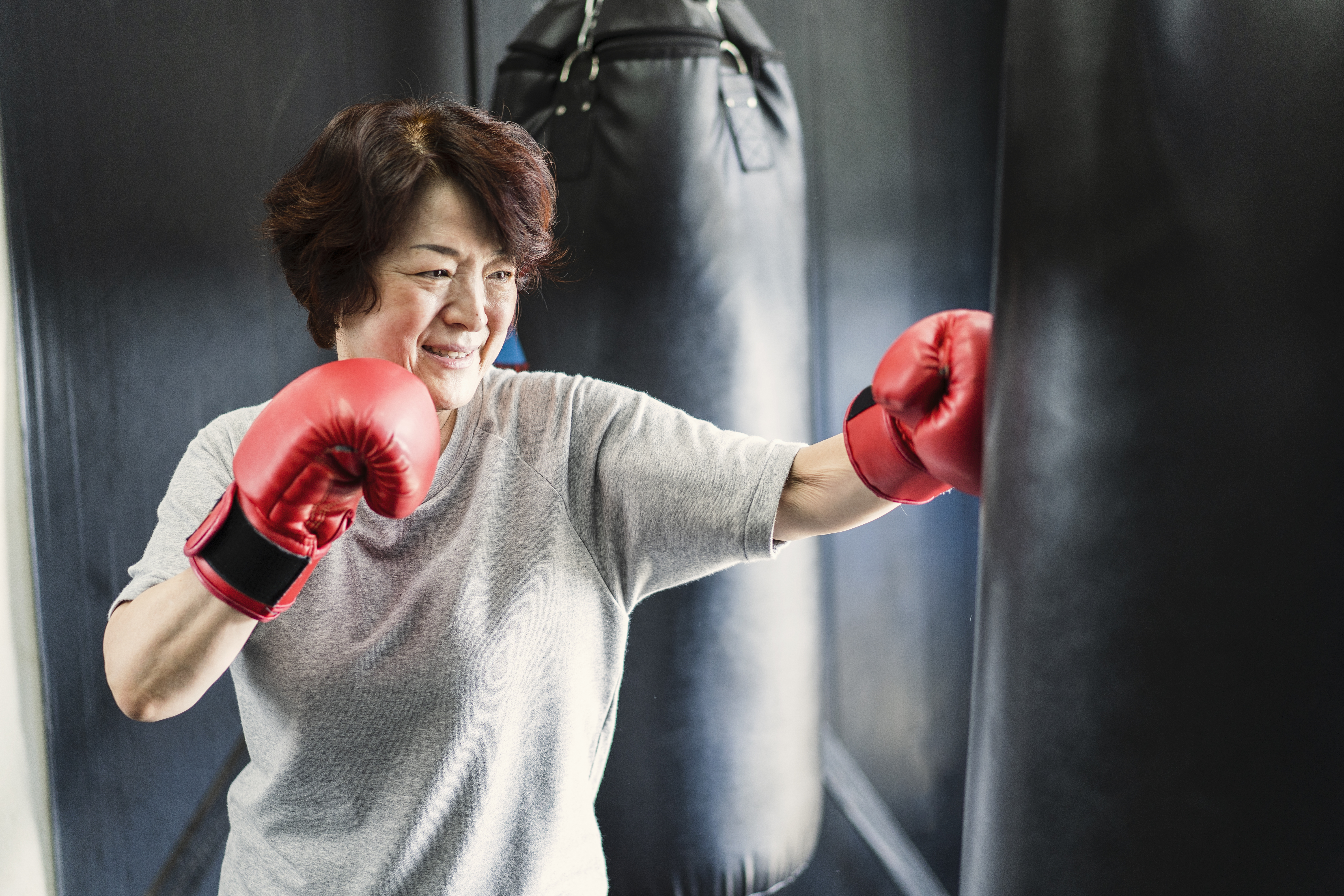Older person with punching gloves